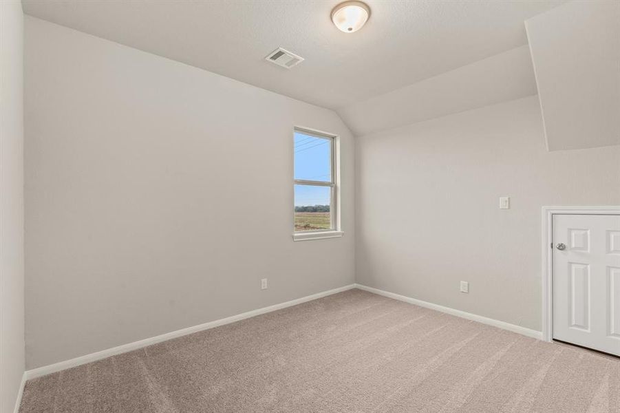 Your secondary bedroom features plush carpet, fresh paint, closet, and a large window that lets in plenty of natural lighting.