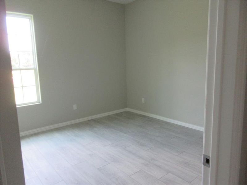 Spare room with a healthy amount of sunlight and light hardwood / wood-style floors