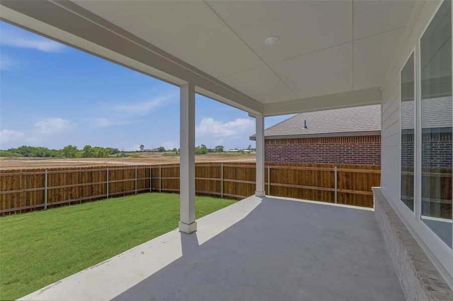 Covered patio with concrete flooring, recessed lighting, and white columns