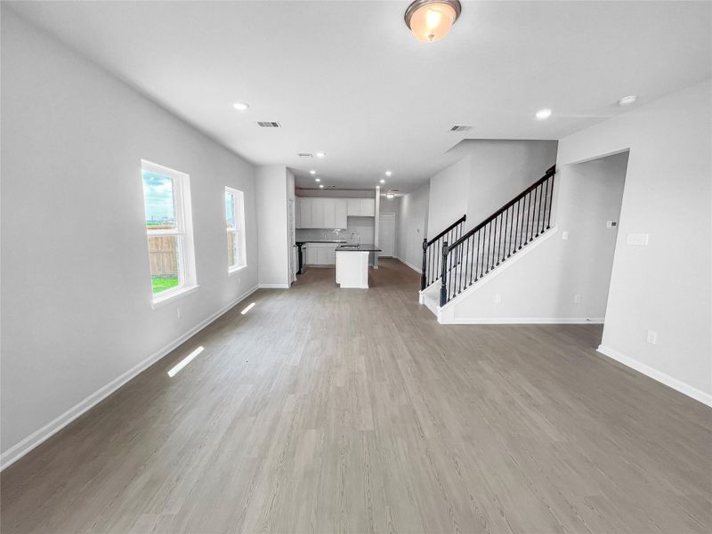 The Waring III- Family Room into Dining Area and Kitchen. Sample image for illustration; upgrades, options, and colors may vary.