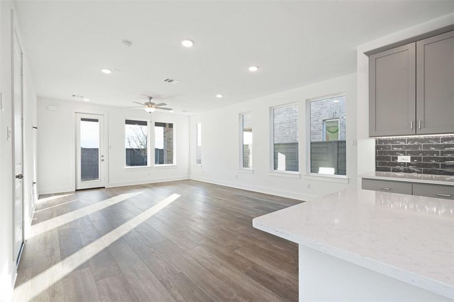 Unfurnished living room with dark hardwood / wood-style floors and ceiling fan