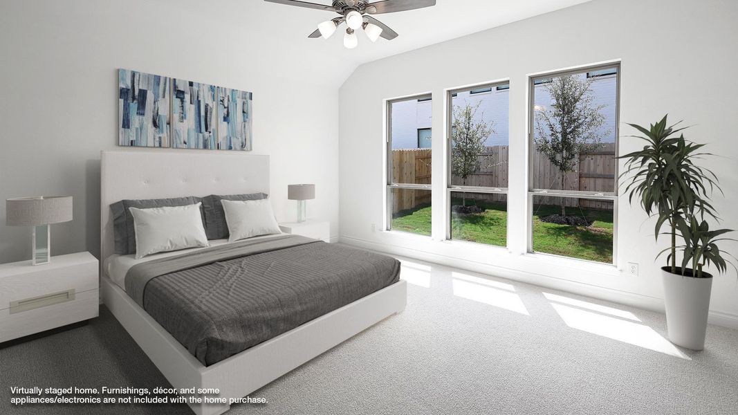 Carpeted bedroom with a ceiling fan and lofted ceiling Carpeted bedroom with a ceiling fan and lofted ceiling