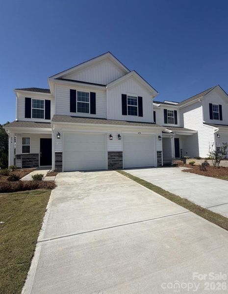 Front exterior of a new home in Bakers Creek, Kannapolis, NC, highlighting curb appeal (Image 1). Front exterior of a new home in Bakers Creek, Kannapolis, NC, highlighting curb appeal (Image 1).