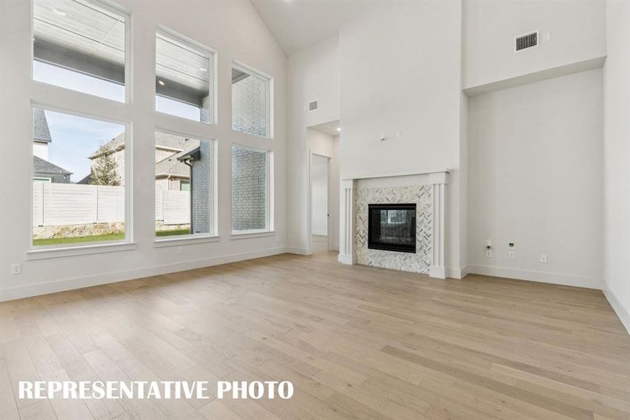 Your new family room offers a wall of windows that flood the home with natural light!  REPRESENTATIVE PHOTO