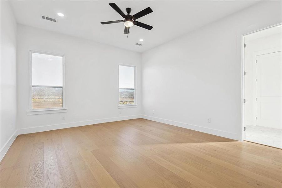 Spare room featuring ceiling fan and light wood-type flooring