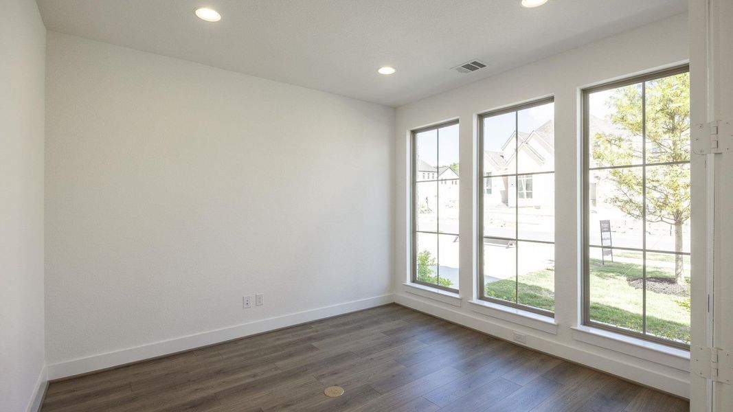 Unfurnished room with dark wood finished floors and recessed lighting Unfurnished room with dark wood finished floors and recessed lighting