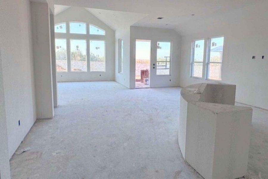 Living room with plenty of natural light and vaulted ceiling
