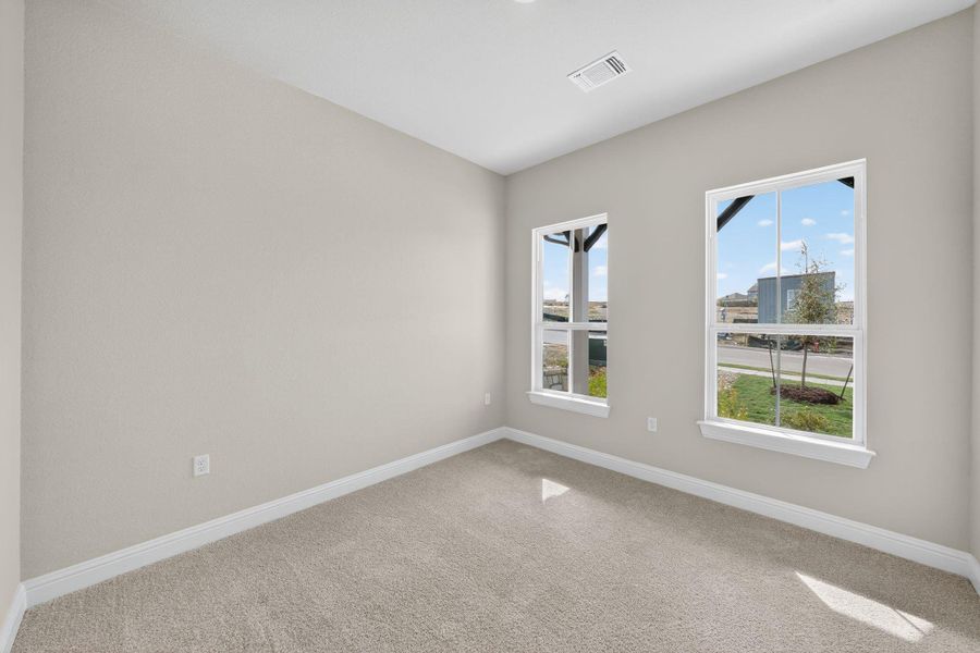 Carpeted empty room with baseboards Carpeted empty room with baseboards