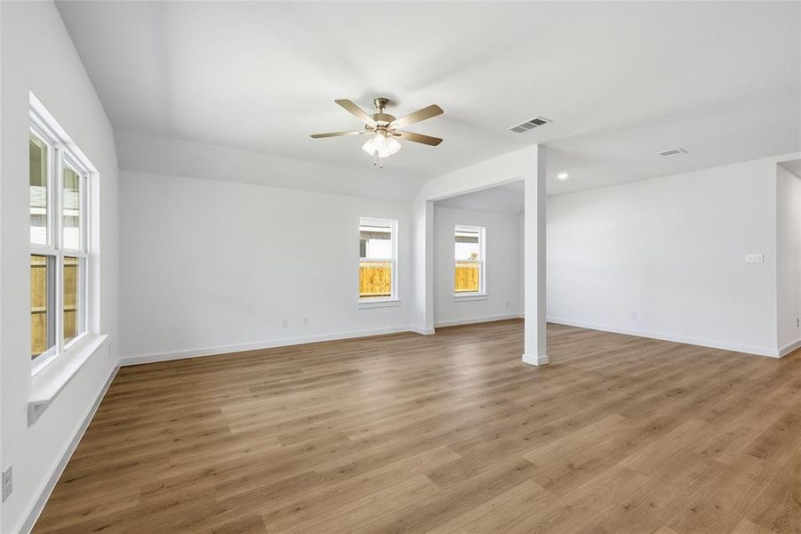 Unfurnished room featuring vaulted ceiling, ceiling fan, light wood finished floors, and recessed lighting