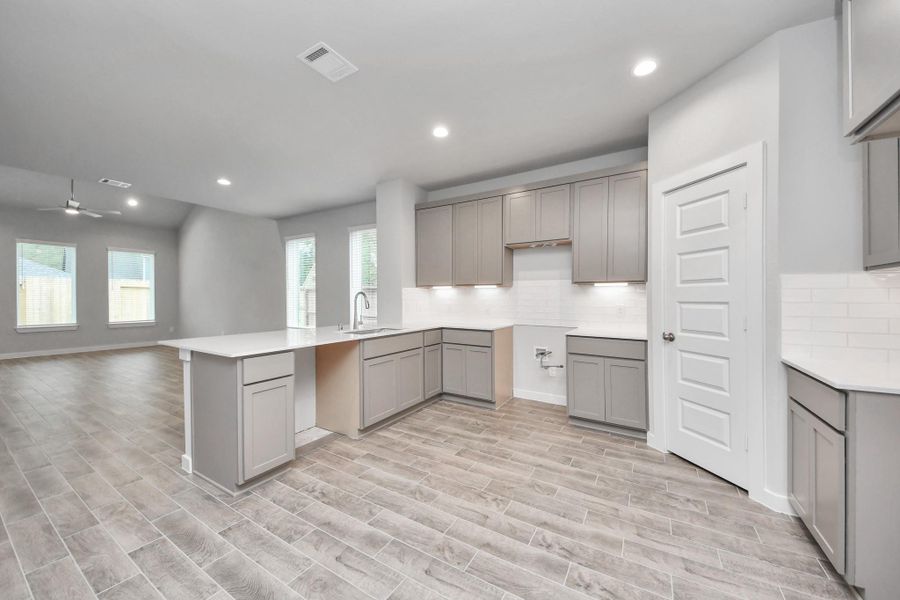 The open concept effortlessly connects the kitchen to the expansive family room, forming a perfect hub for gatherings. This seamless flow creates an inviting space where cooking and socializing come together harmoniously. Sample photo of completed home with similar floor plan. Actual colors and selections may vary.