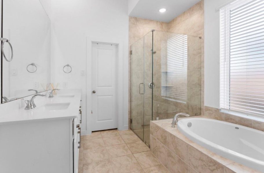 Elegant master bathroom with a beautiful garden tub and separate glass shower. Elegant master bathroom with a beautiful garden tub and separate glass shower.