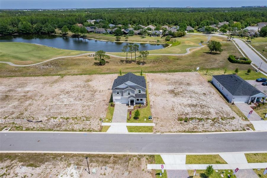 Front exterior of a new home in Gray Hawk at Hole Two, Daytona Beach, FL, highlighting curb appeal (Image 36). Front exterior of a new home in Gray Hawk at Hole Two, Daytona Beach, FL, highlighting curb appeal (Image 36).