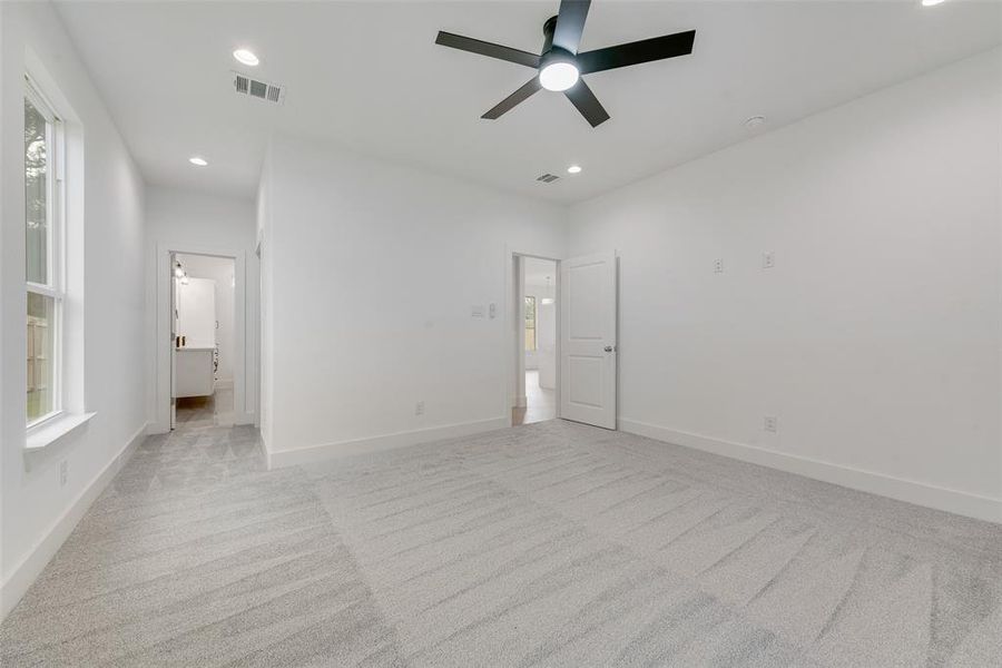 Unfurnished bedroom featuring light carpet, recessed lighting, a ceiling fan, and ensuite bath Unfurnished bedroom featuring light carpet, recessed lighting, a ceiling fan, and ensuite bath