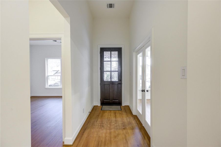 Welcome home through a charming front door that opens into a bright, inviting hallway with elegant wood flooring and abundant natural light. Welcome home through a charming front door that opens into a bright, inviting hallway with elegant wood flooring and abundant natural light.