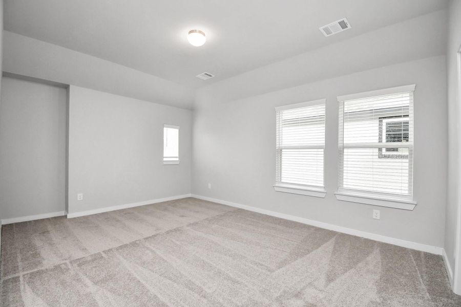 Come upstairs and enjoy a day of leisure in this fabulous game room! This is the perfect hangout spot or adult game room! Features plush carpet, high ceilings, custom paint and windows for plenty of natural light. Sample photo of completed home with similar floor plan. Actual colors and selections may vary.