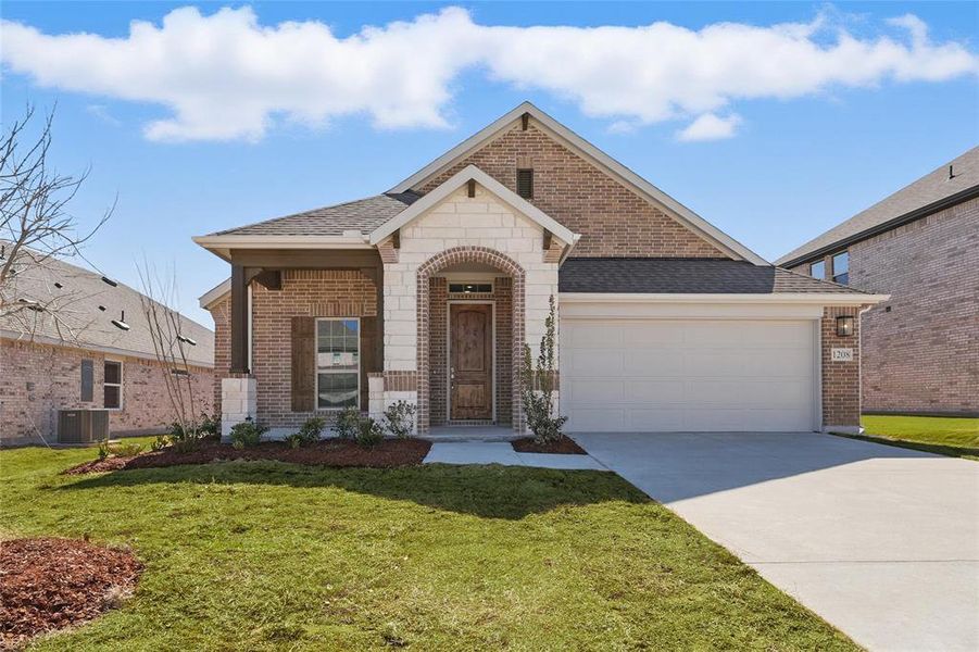 View of front of property with brick siding, a front yard, a garage, cooling unit, and driveway