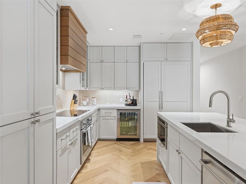 Contemporary kitchen featuring light-colored cabinetry and a large center island. Contemporary kitchen featuring light-colored cabinetry and a large center island.