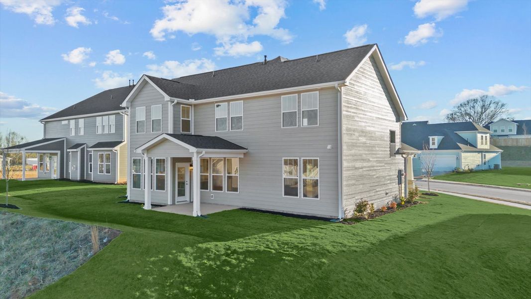 Rear covered porch creates a seamless extension of this home’s elegant design