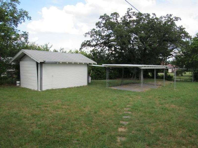 View of grassy yard with an outdoor structure View of grassy yard with an outdoor structure