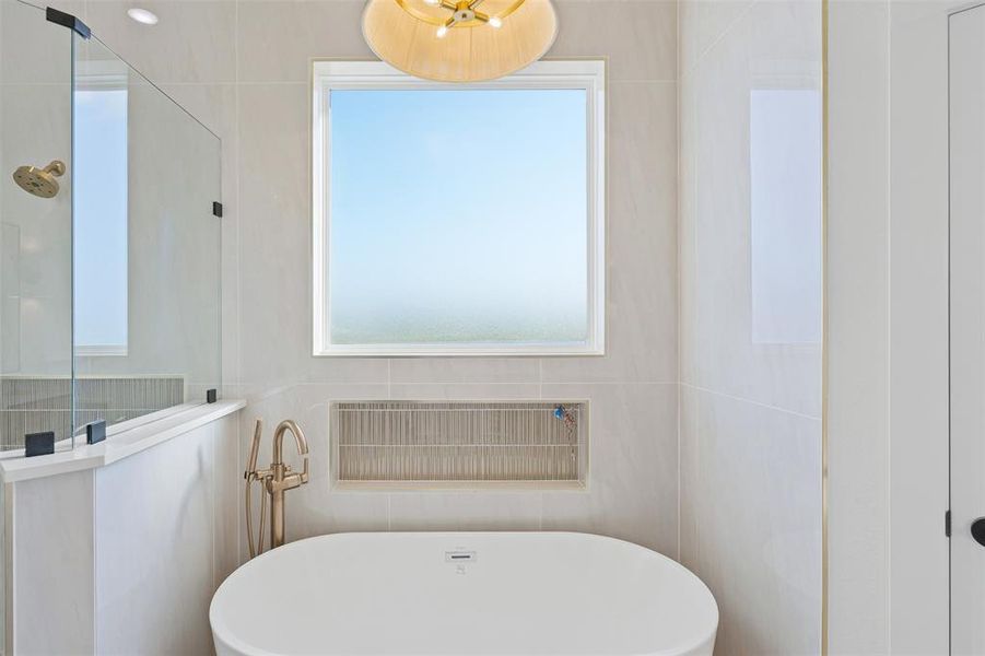 Bathroom with tile walls and independent shower and bath