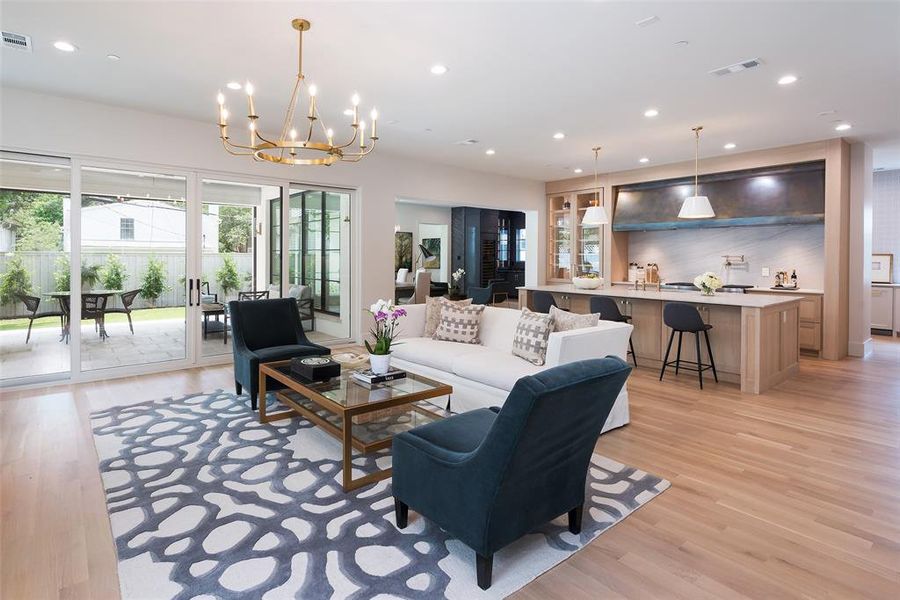 Living room featuring a notable chandelier and light hardwood / wood-style flooring