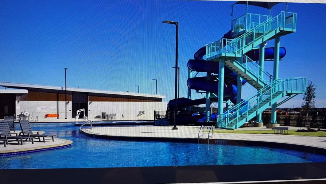 An inviting aquatic center features a resort-style swimming pool and a thrilling water slide structure.