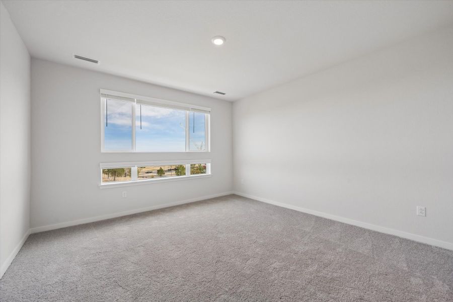 A room with a window and a carpet.