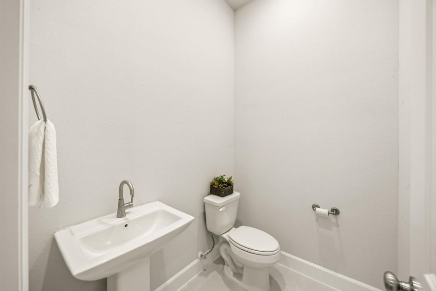 A downstairs retreat featuring a timeless pedestal sink, offering both style and convenience. (Pick your mirror!) A downstairs retreat featuring a timeless pedestal sink, offering both style and convenience. (Pick your mirror!)
