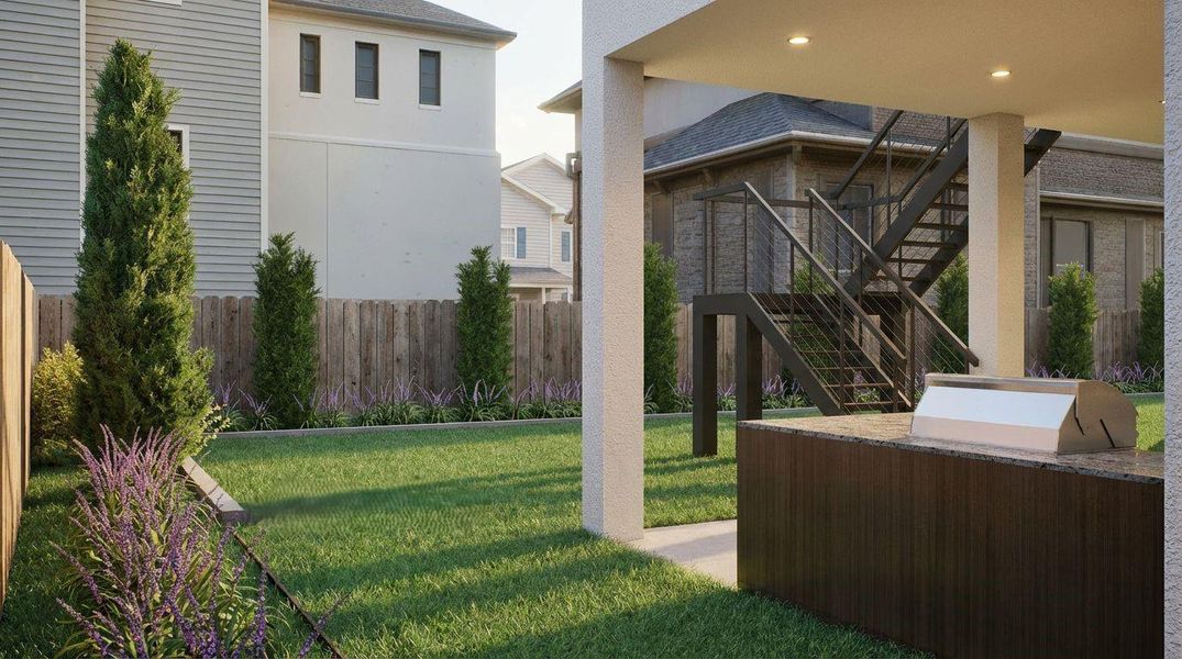 This private, fully fenced backyard boasts a manicured green grass lawn, elegant tiered perimeter landscaping, and a protected covered patio. Featuring a modern, built-in summer kitchen island with a premium stainless steel grill, providing an inviting space to cook, dine, and relax.