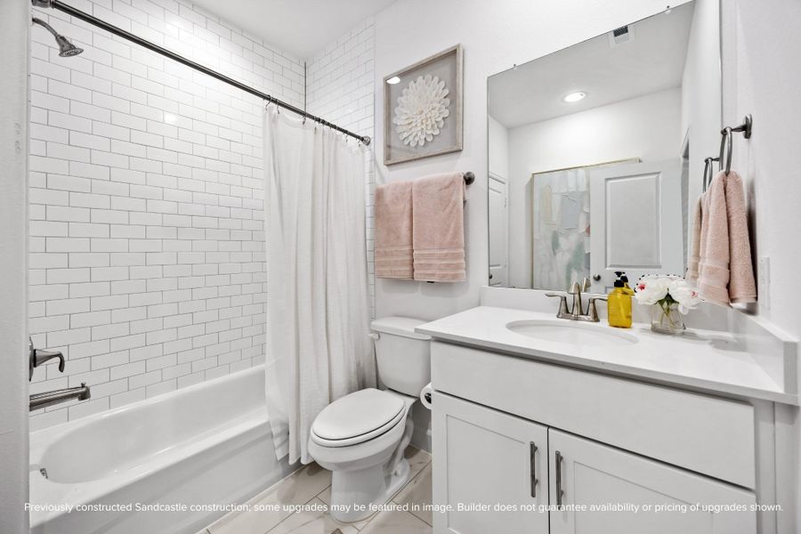 Classic and clean, this hall bath brings timeless design and everyday ease. Finishes like brushed nickel and subway tile never go out of style. (Finishes may vary.)