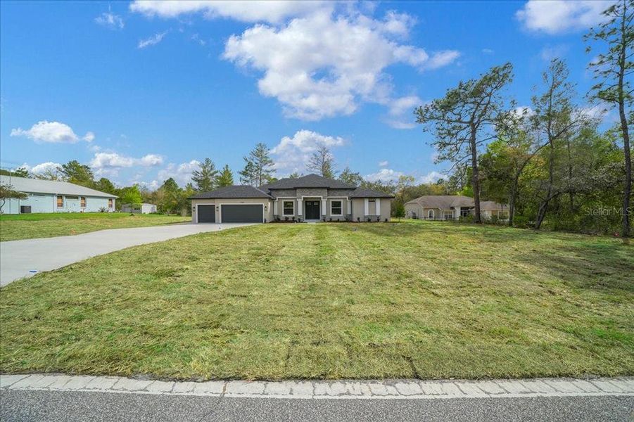 Front exterior of a new home in , Weeki Wachee, FL, highlighting curb appeal (Image 29).