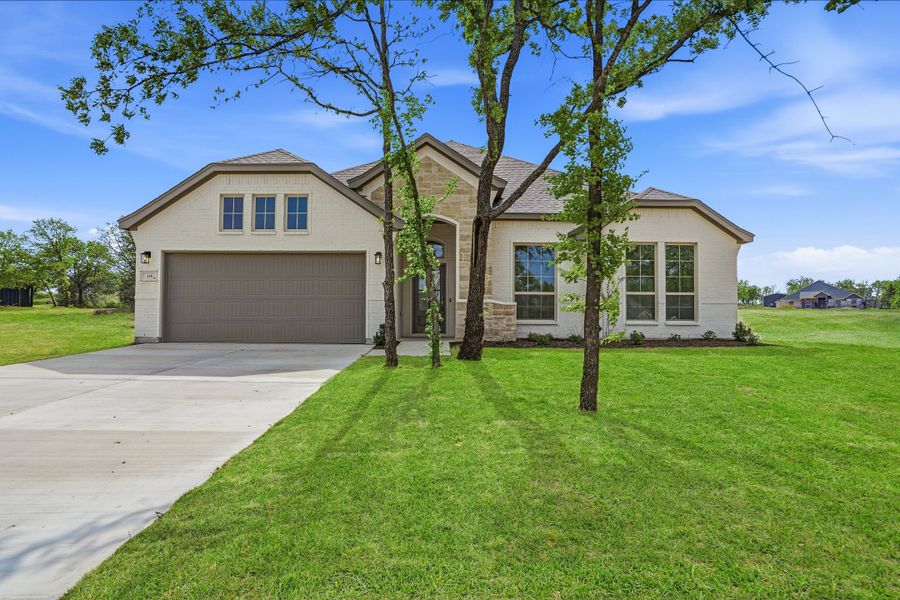 Front exterior of a new home in Arbor Oaks, Boyd, TX, highlighting curb appeal (Image 2). Front exterior of a new home in Arbor Oaks, Boyd, TX, highlighting curb appeal (Image 2).