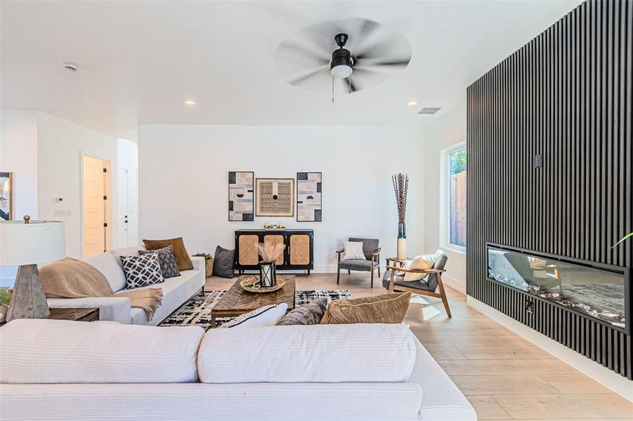 Living room with recessed lighting, wood finished floors, and ceiling fan Living room with recessed lighting, wood finished floors, and ceiling fan