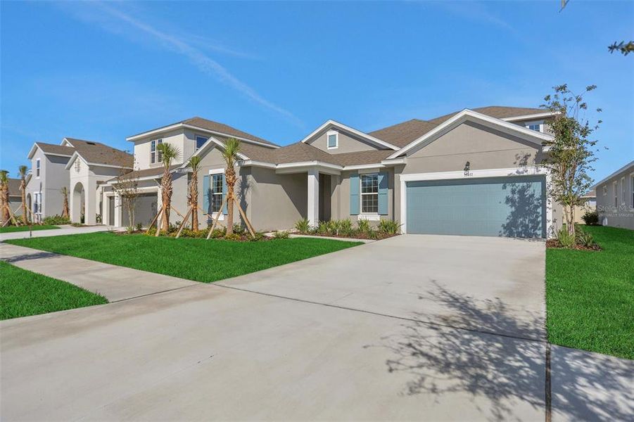 Front exterior of a new home in Angeline, Land O' Lakes, FL, highlighting curb appeal (Image 25).