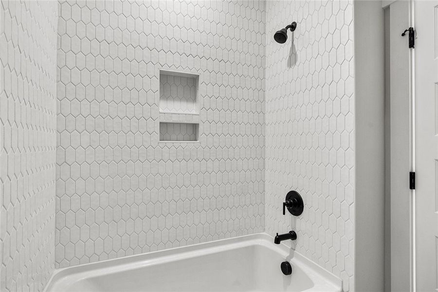 A well-appointed bath with striking tiled walls an A well-appointed bath with striking tiled walls an
