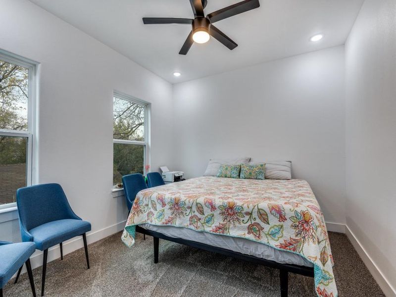 Bedroom with carpet, ceiling fan, and recessed lighting