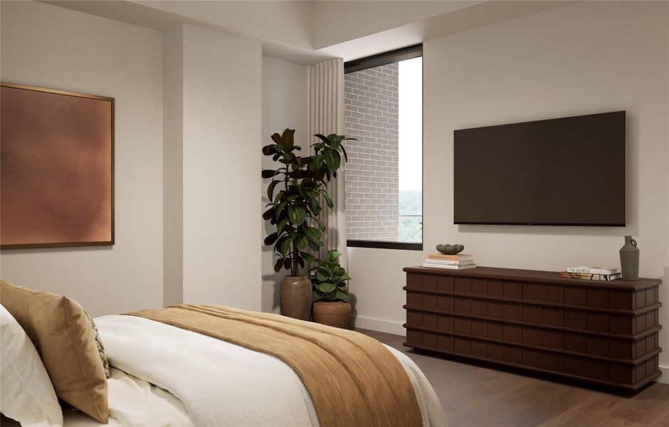 Primary bedroom showcasing soft natural light, wood flooring, and warm neutral finishes. Features a picture window creating a serene, well-balanced retreat.