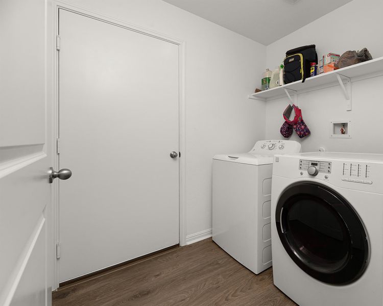 Laundry area with dark wood-type flooring and washer and clothes dryer