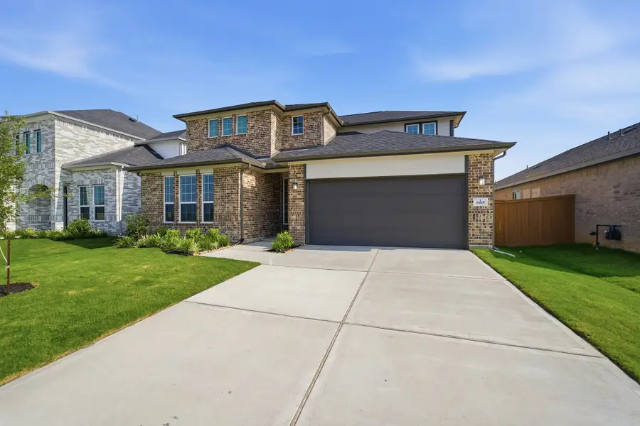 Front exterior of a new home in Sunterra Lakes, Brookshire, TX, highlighting curb appeal (Image 2).