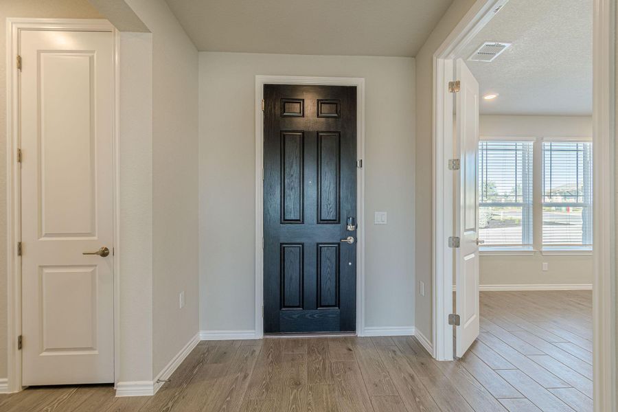 Entrance foyer with light wood-type flooring and recessed lighting Entrance foyer with light wood-type flooring and recessed lighting