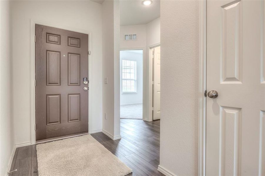Entrance foyer featuring baseboards and luxury vinyl plan flooring Entrance foyer featuring baseboards and luxury vinyl plan flooring