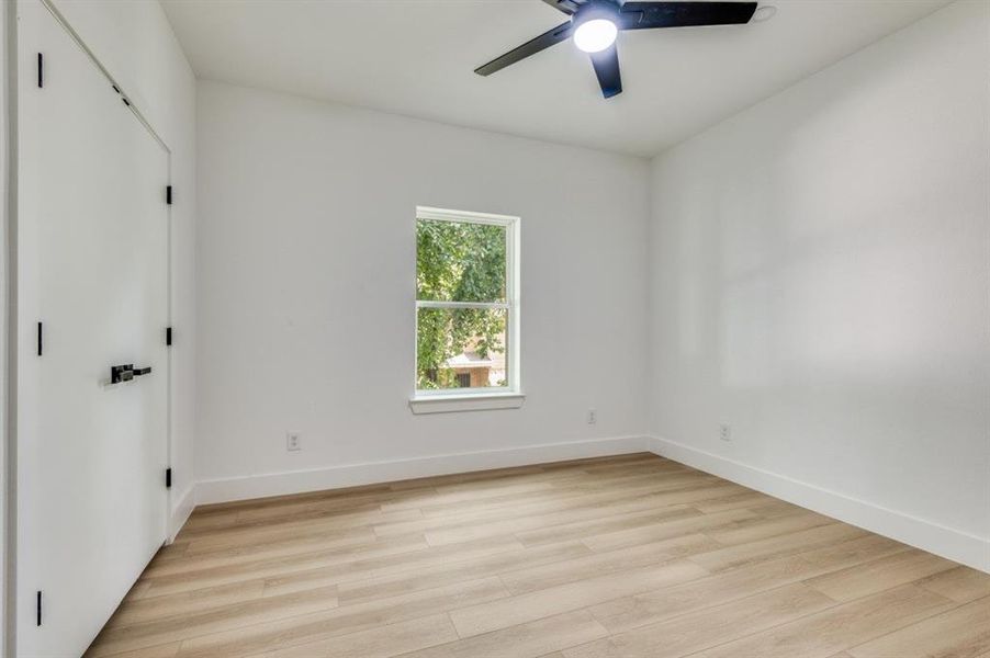 Unfurnished bedroom with light wood-style floors and a ceiling fan Unfurnished bedroom with light wood-style floors and a ceiling fan