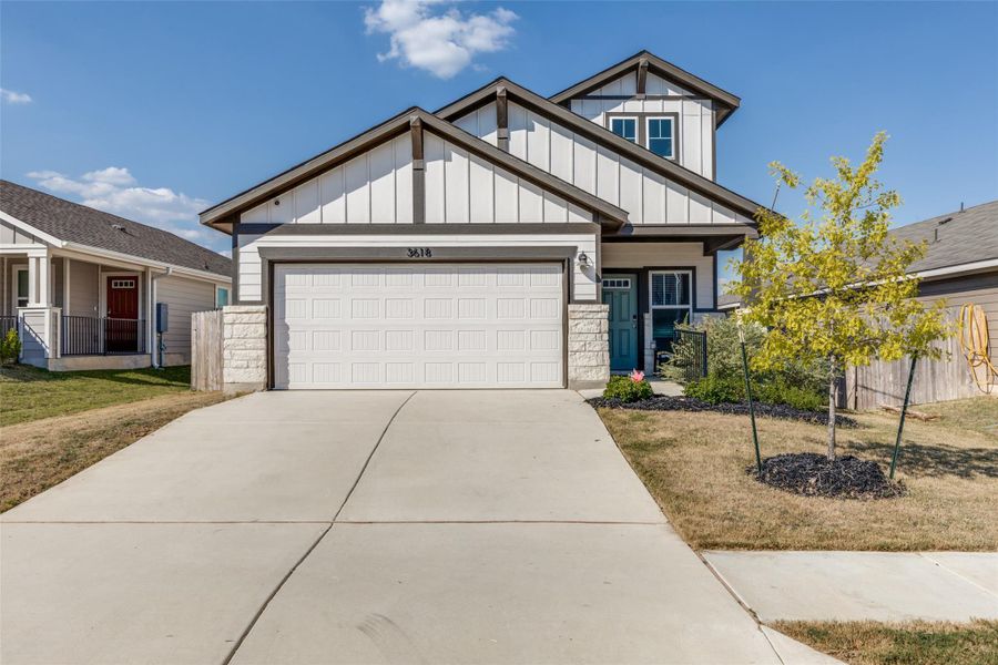 Craftsman house with board and batten siding, concrete driveway, stone siding, and a garage