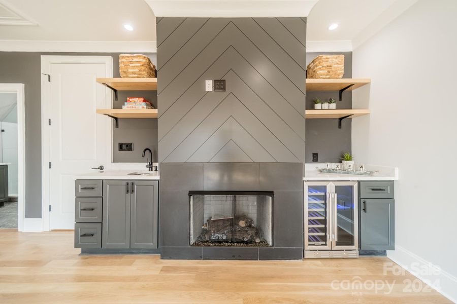 Upper level entertainment room w/fireplace, sink, bev fridge