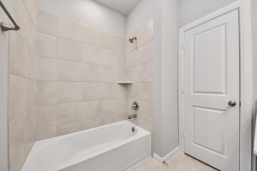 Bathroom with tub and shower combination.