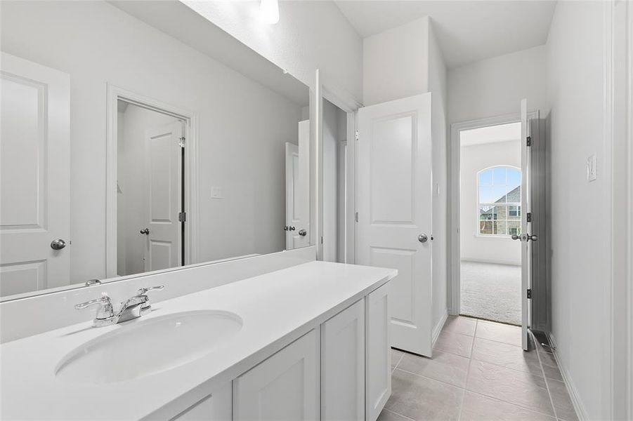 Bathroom featuring vanity and light tile patterned floors Bathroom featuring vanity and light tile patterned floors