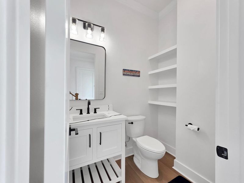Downstairs half bath located at entryway