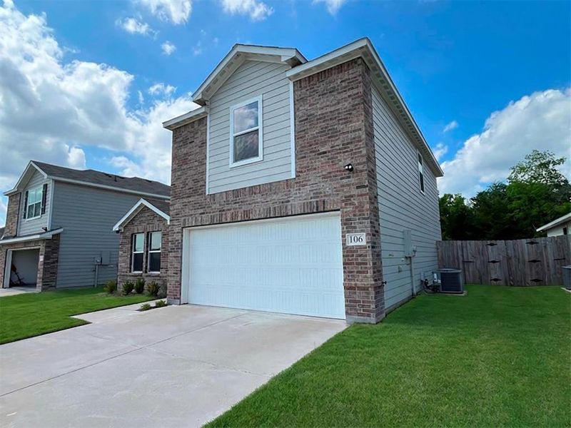 Front exterior of a new home in Labein Villas, Greenville, TX, highlighting curb appeal (Image 19).