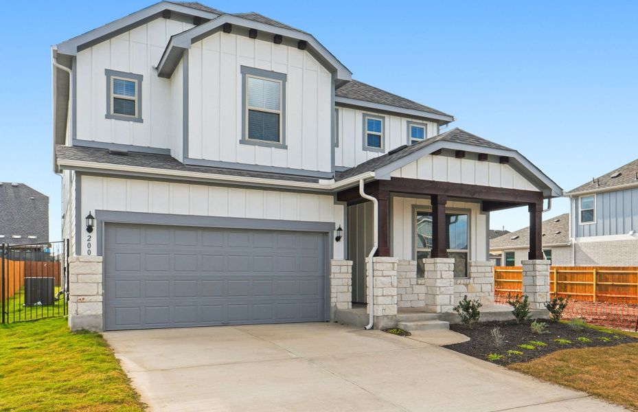 Front exterior of a new home in Santa Rita Ranch, Liberty Hill, TX, highlighting curb appeal (Image 25). Front exterior of a new home in Santa Rita Ranch, Liberty Hill, TX, highlighting curb appeal (Image 25).