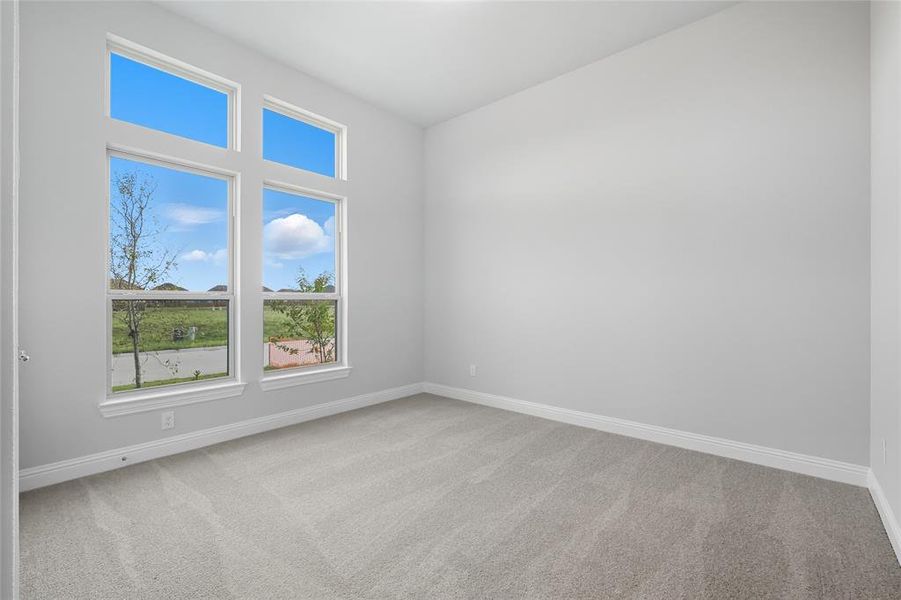 Unfurnished room with light colored carpet and baseboards